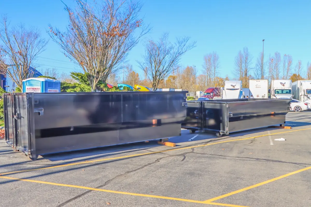 Professional dumpster rental service with roll-off container on residential driveway in Oak Hill